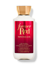 A bottle of Bath & Body Works Forever Red body lotion, featuring a white bottle with a metallic gold cap and a red label with gold lettering, set against a plain white background.
