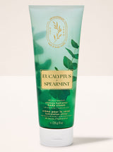 Green tube of Eucalyptus Spearmint body cream on a light background