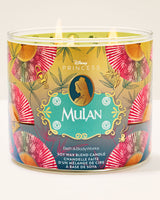 Disney Princess Mulan Bath & Body Works scented candle in a clear glass jar with three wicks, featuring a gold, teal, and pink fan-patterned label.