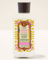 A bottle of Bath & Body Works Dreaming of Rio Daily Nourishing Body Lotion. The product is in a white bottle with a black cap and a colorful label featuring pink, yellow, and green patterns.
