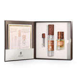 Perfume set with three bottles and a leaflet in an open box on a white background