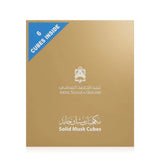 A square gold box of Abdul Samad Al-Qurashi Solid Musk Cubes, featuring a blue corner label that reads '6 CUBES INSIDE' and white text with the brand name and logo.