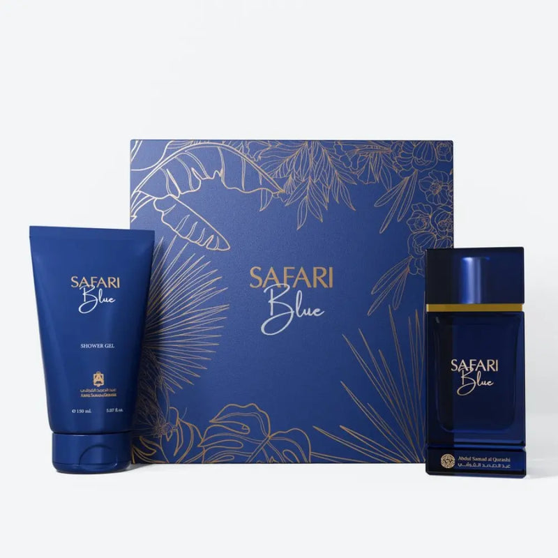 Safari Blue fragrance gift set featuring a blue shower gel tube, a blue perfume bottle with gold detailing, and a matching blue box with gold tropical line art, set against a clean white background.