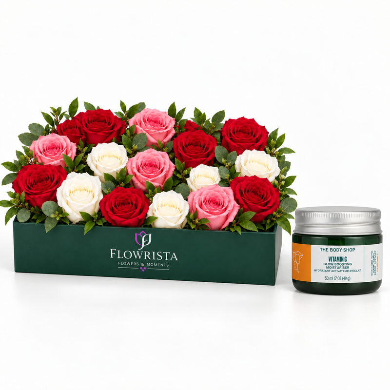 A gift set featuring a box of fresh roses in red, pink, and white from Flowrista, paired with a jar of The Body Shop Vitamin C Brightening Face Cream on a clean white background.
