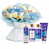 A floral gift set featuring a large bouquet of blue, white, and peach flowers wrapped in light blue paper, alongside four Bath & Body Works Butterfly scented products including a body spray, lotion, hand cream, and a body wash tube.