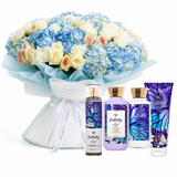A floral gift set featuring a large bouquet of blue, white, and peach flowers wrapped in light blue paper, alongside four Bath & Body Works Butterfly scented products including a body spray, lotion, hand cream, and a body wash tube.