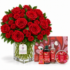 A large bouquet of red roses in a clear glass vase with green stems, displayed with matching red gift items including a box, hand cream tubes, a bottle, and a tin on a white background. The tag on the vase reads Flowrista.