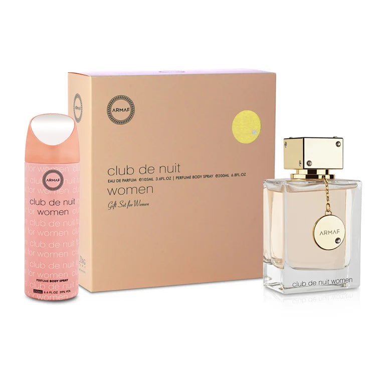 Armaf Club de Nuit Women perfume gift set featuring a pink body spray bottle, a clear glass spray bottle with gold cap, and a beige cardboard box with product branding.