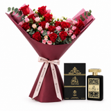 Ashek Al Oud perfume by Almas and matching box beside a Flowrista red rose bouquet