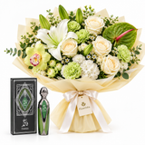 Fakher perfume and presentation box beside a Flowrista white and green mixed bouquet in cream wrapping
