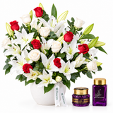 Saher Alkalmet bakhoor and mamoul beside Flowrista red roses and white lilies in a white pot
