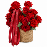 Red roses and eucalyptus in a woven basket with long red Flowrista ribbon