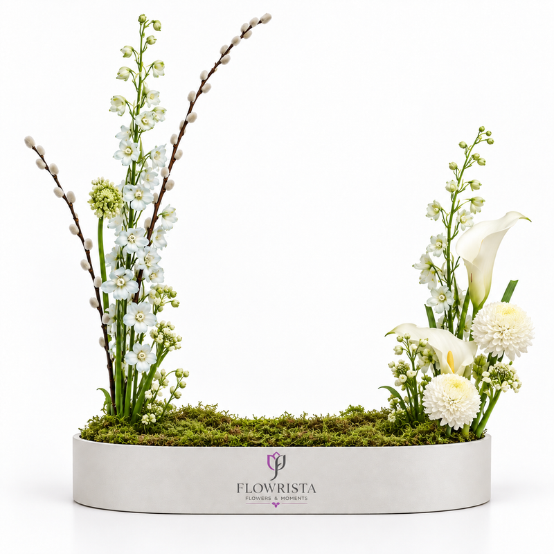 Flowrista white garden arrangement with delphinium, calla lilies, chrysanthemums and pussy willow in a white oval tray