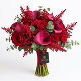 Red roses and burgundy calla lilies with eucalyptus red floral accents and Flowrista gift tag