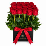 Fresh red roses with green foliage in a black square Flowrista flower box with red satin ribbon