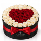 Red rose heart surrounded by cream white roses in a black Flowrista hatbox with red satin bow