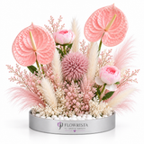 Pink anthurium, peony, and pampas grass arrangement in a Flowrista round planter