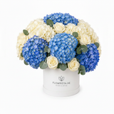 Flowrista blue and white hydrangeas with white roses hat box on white background
