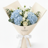 Flowrista blue hydrangea and white roses bouquet in cream branded paper with white satin ribbon