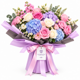 Blue hydrangea, pink and white roses bouquet in Flowrista lilac wrap with pink bow
