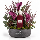 Purple Heart Diamond perfume with artificial purple calla-style flowers and burgundy sprigs in a grey Flowrista bowl
