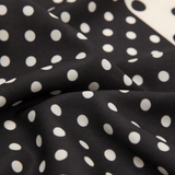 Close-up detail of Mango black and white polka dot satin scarf texture