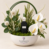 Black Carbon Diamond perfume with artificial white calla-style flowers and green arch in a white Flowrista bowl
