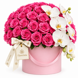 Flowrista bright pink roses and cascading white orchids in a pink hatbox with handle