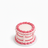 One-kilo Sugar Sweet pink-and-white vintage birthday cake with piped garlands and ruffles