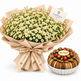 Flowrista white daisy bouquet beside caramelized sesame tray in white faceted plate