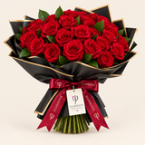 Flowrista red rose bouquet in black gold-edged wrapping with burgundy ribbon