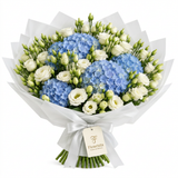 Blue hydrangeas and white lisianthus with green buds in white wrapping and a Flowrista gift tag