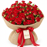 Red spray rose bouquet in natural burlap with a red satin bow and Flowrista gift tag