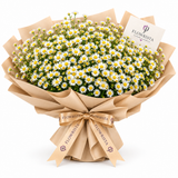 Large white daisy bouquet with yellow centers in tan wrap and Flowrista ribbon