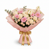 Flowrista Whispers of Grace bouquet with white roses blush spray roses pink gerbera and anthurium in pink paper