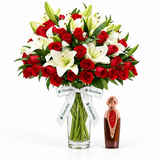 Asser 100ml perfume beside Flowrista red roses and white lilies in a clear glass vase