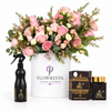 Ashiq Al Oud air freshener and bakhoor beside pink and cream roses in a white Flowrista box