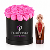 Asser perfume beside bright pink roses in a black round Flowrista flower box
