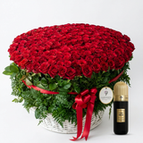 Cuban Tobacco 100 ml perfume beside a Flowrista basket of 1000 red roses with green foliage and red ribbon