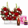 Asser perfume and Saher mamoul beside Flowrista red rose and burgundy orchid arrangement