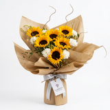 Sunshine Blooms bouquet of yellow sunflowers and white carnations with silver ribbon and Flowrista Flowers & Moments gift tag