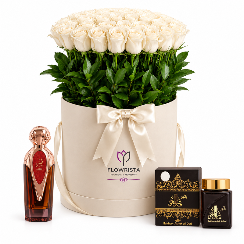 Asser perfume and Bakhoor Ashek Al Oud beside white roses in an ivory Flowrista flower box