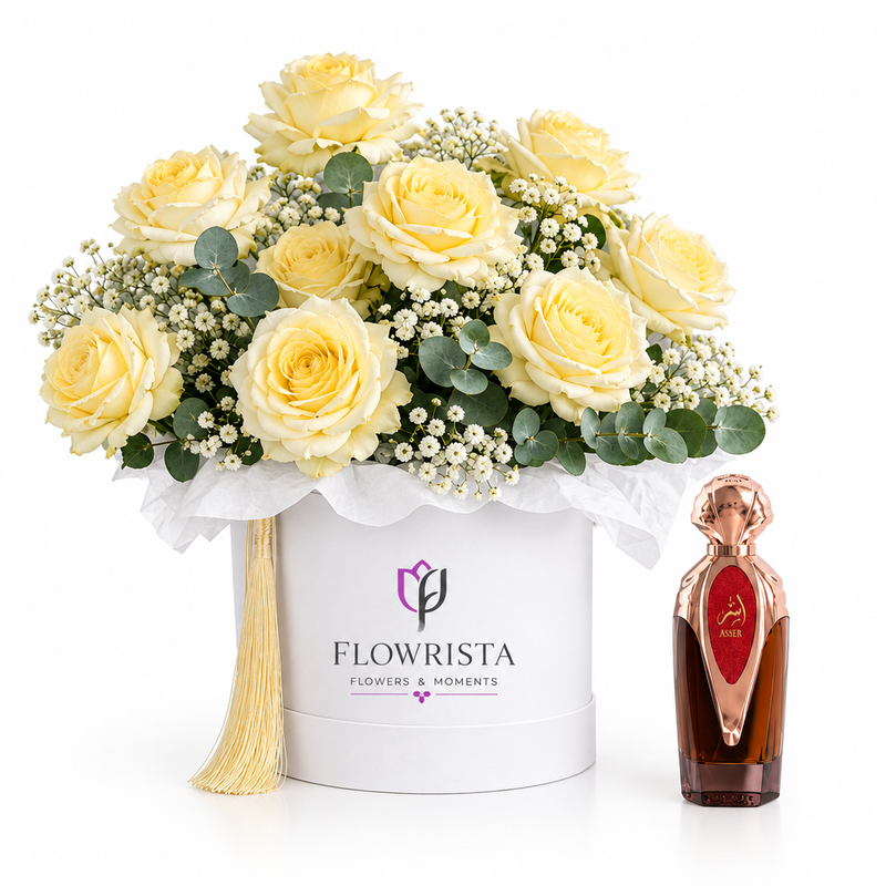 Asser perfume beside cream roses and baby's breath in a white Flowrista flower box
