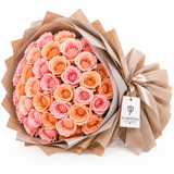 Peach and pink roses in Flowrista beige wrap with tag