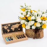 Tobacco Collection perfume set beside a Flowrista basket of white and yellow roses, lisianthus and sunflowers