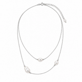 Delicate silver-tone necklace with pearl-like accents on white background