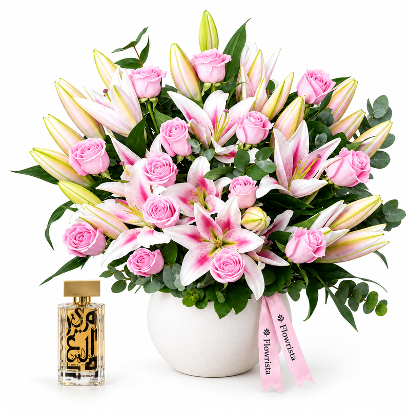 Amir Al Oud Gold perfume beside Flowrista pink roses and pink-and-white lilies in a white pot
