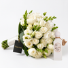 Riviera Sunset perfume beside a Flowrista white bridal rose bouquet with greenery