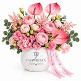 Pink mixed flowers and anthuriums in white Flowrista vase with pink ribbons