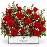 Fresh red rose arrangement with eucalyptus and white filler flowers in a rectangular Flowrista box